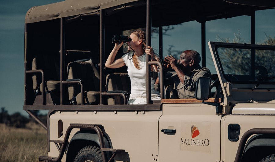 Guests glassing wildlife from a Salinero game-drive vehicle in the central Serengeti
